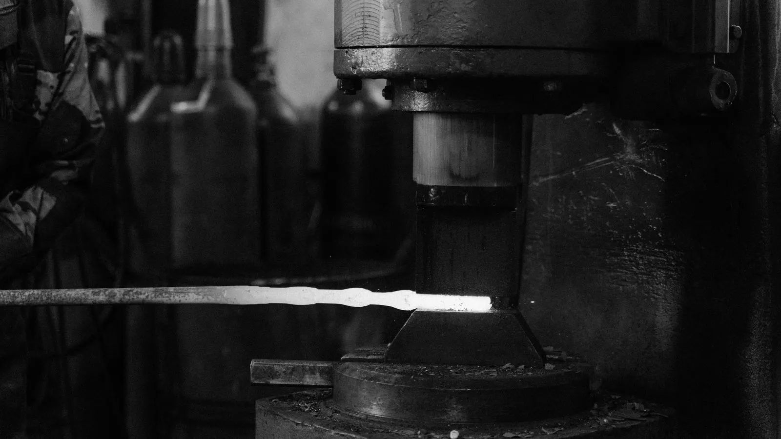 Close up of a metal caliper measuring a forged shaft