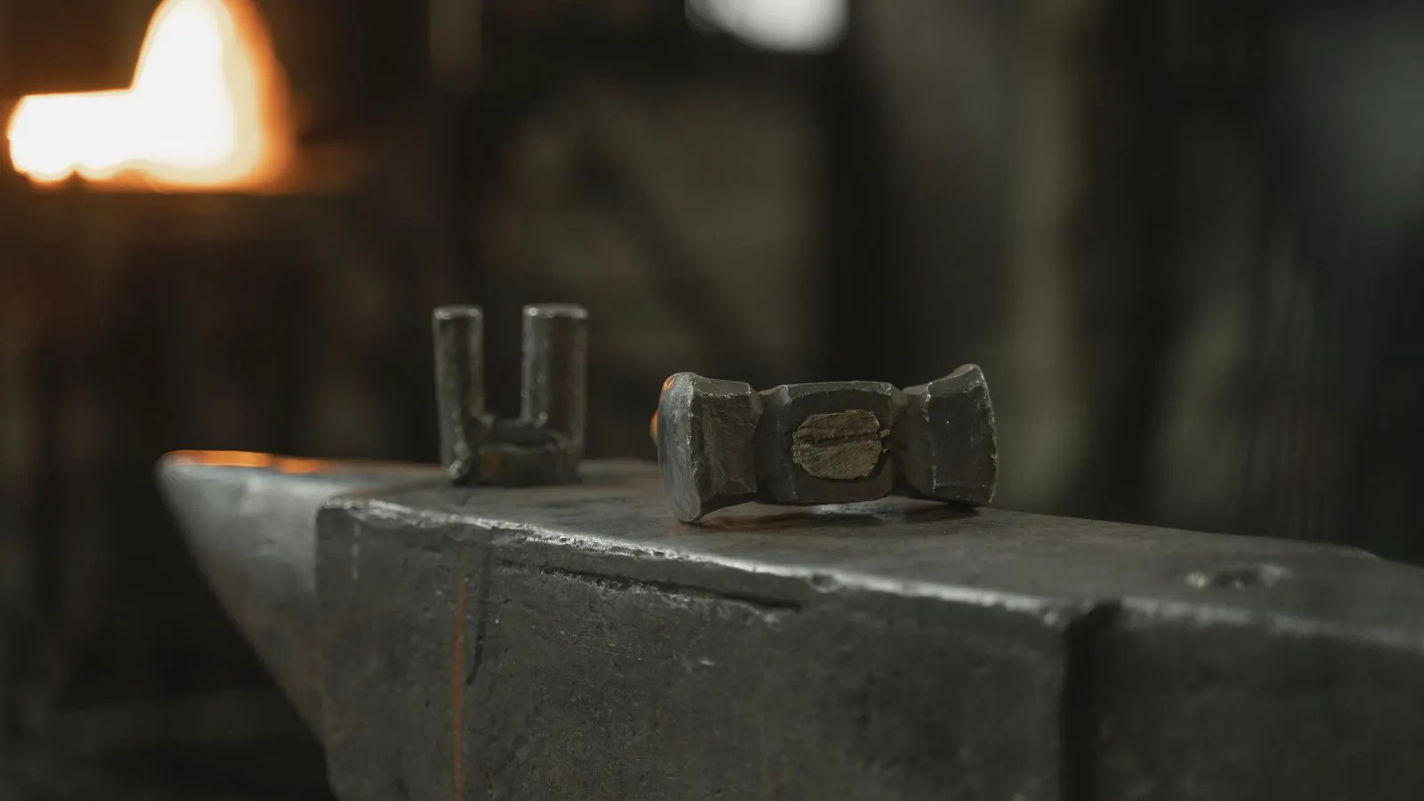 A machined forged steel part resting on a metal inspection table