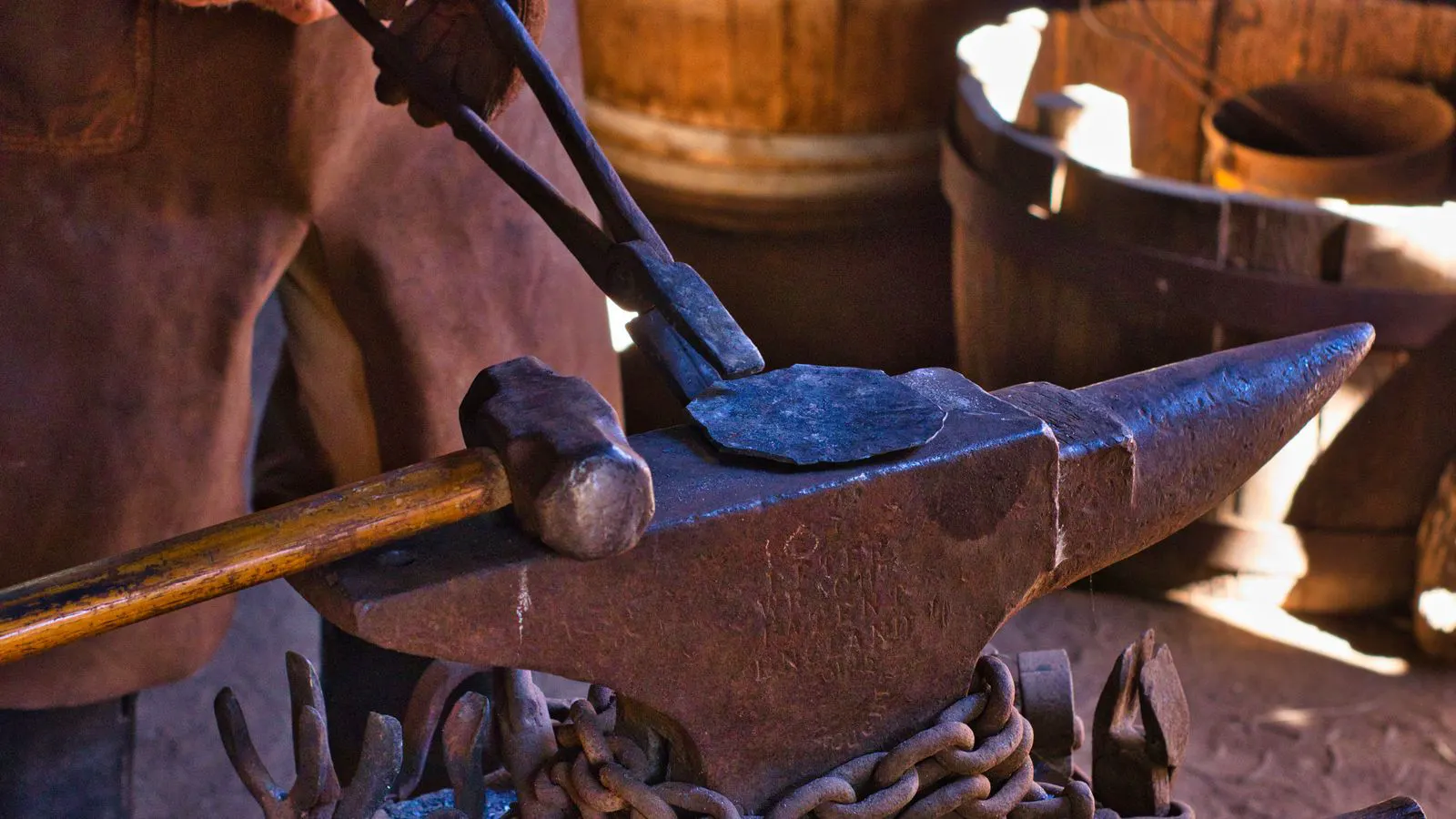 Engineer inspecting a forged part against a die cavity with calipers nearby.